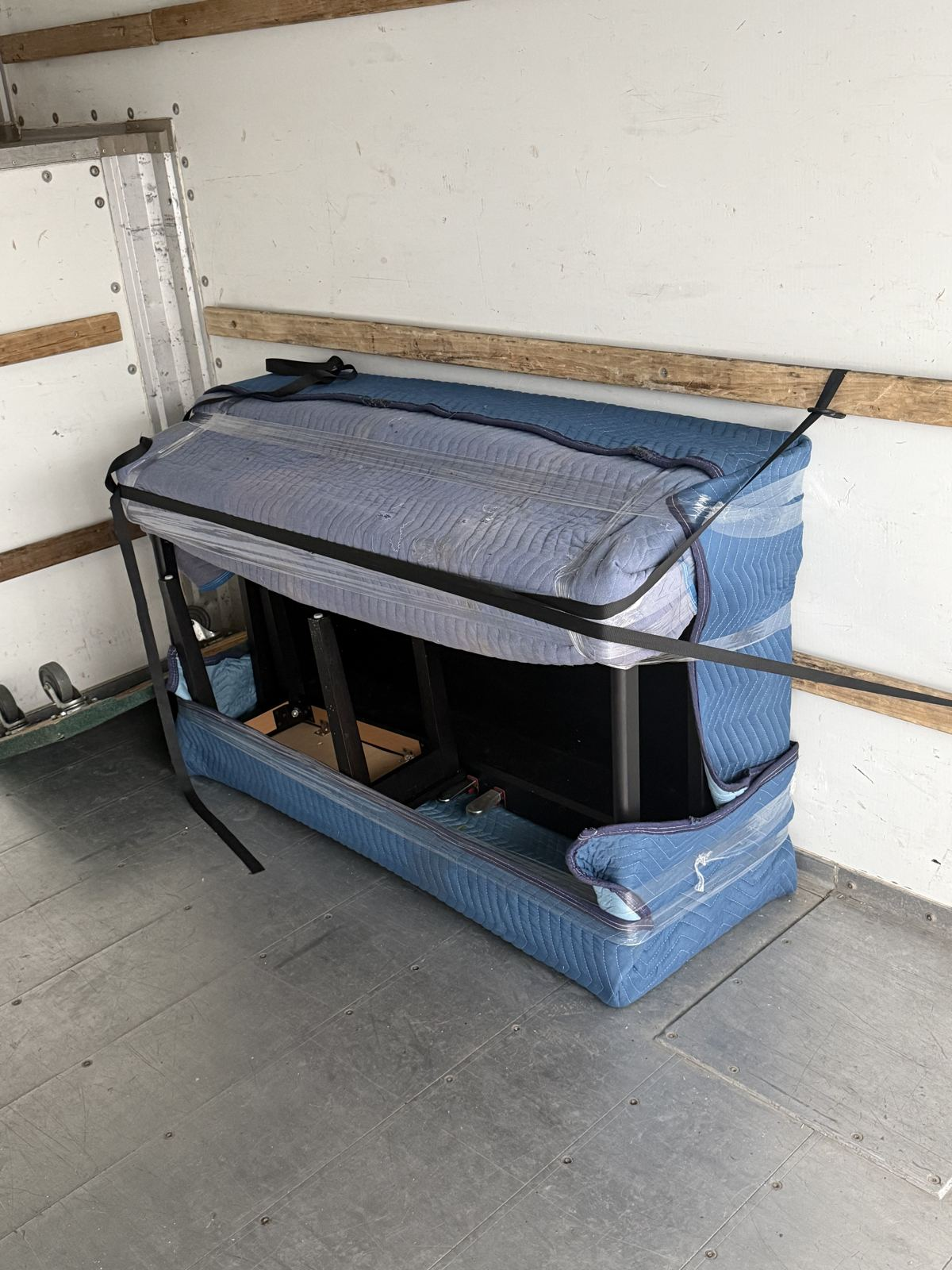 Piano wrapped and secured inside an N&N Brothers moving truck in Toronto