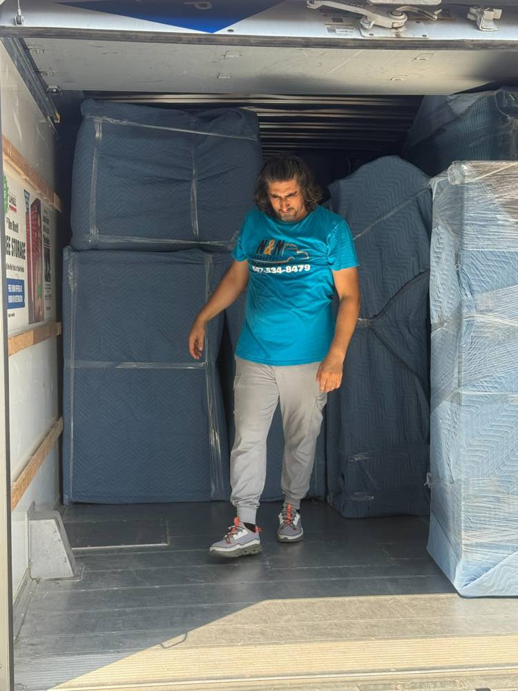 A moving truck loaded with packed and wrapped furniture in Oakville